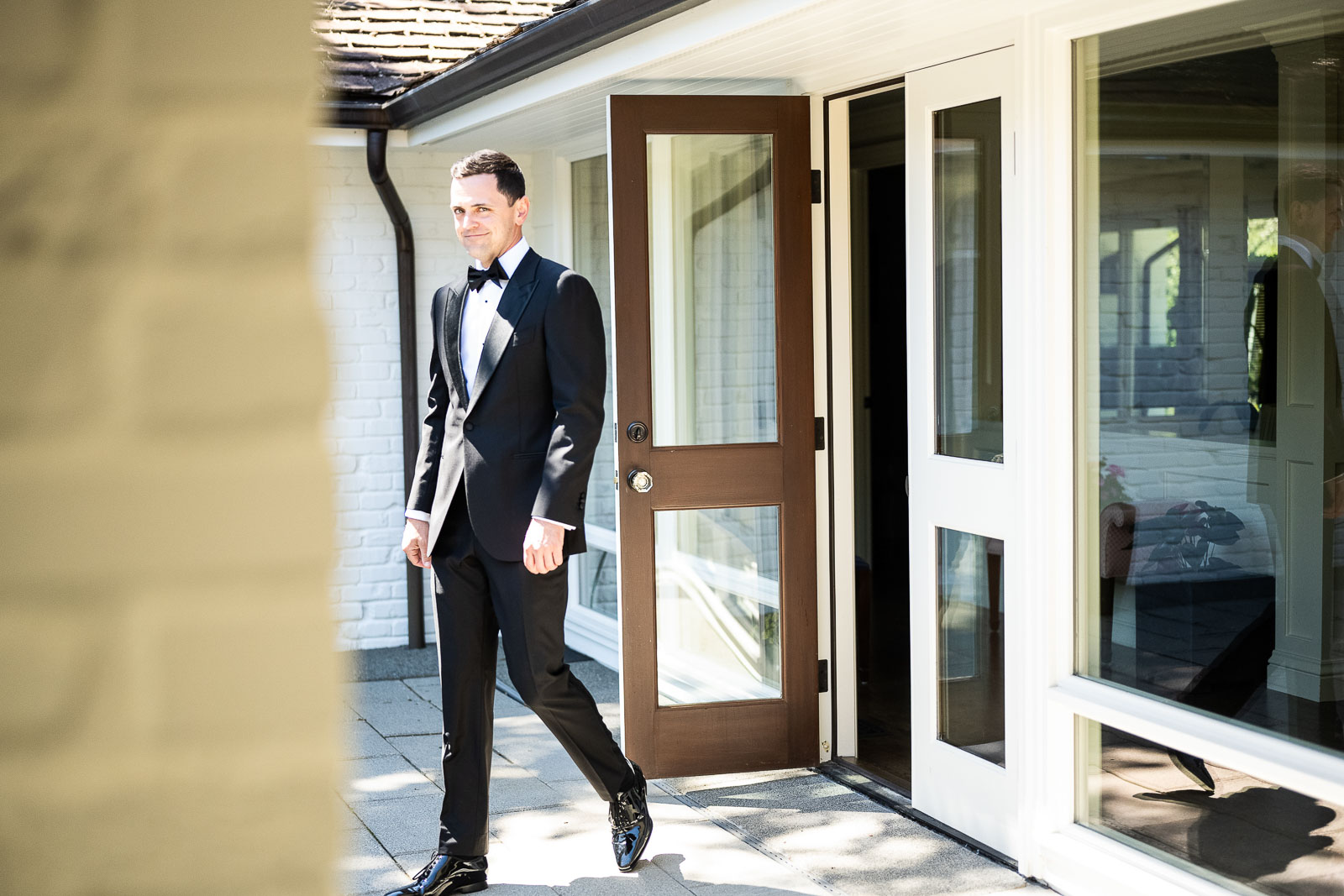 Groom walks out of door ready for ceremony