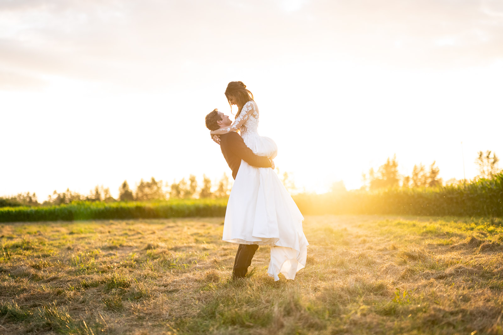 Couple stands in field near seattle for seattle wedding photographer